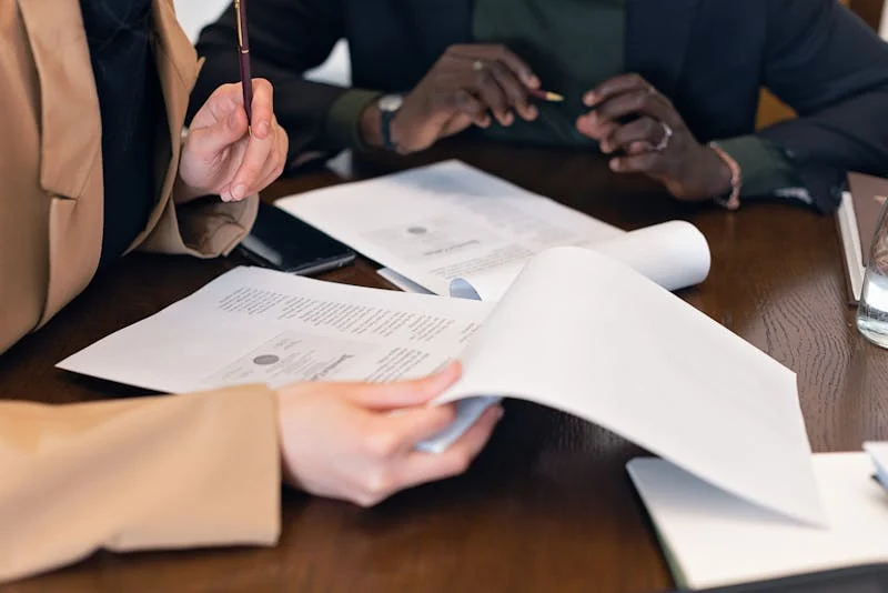 Close-up of people reviewing analytical documents